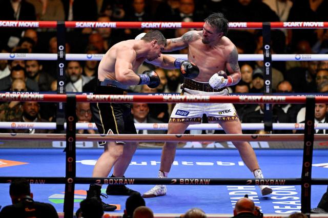 Ukraine's Oleksandr Usyk (R) fights Netherlands' Rico Verhoeven (L) during their WBC World Heavyweight Championship 'Glory in Giza' boxing match at the Pyramids of Giza on May 23, 2026. Heavyweight boxing king Oleksandr Usyk retained his titles after a dramatic and controversial stoppage victory over kick-boxer Rico Verhoeven with a second left of the 11th round in Egypt on May 23. (Photo by Khaled DESOUKI / AFP)