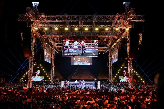 Ukraine's Oleksandr Usyk fights Netherlands' Rico Verhoeven during their WBC World Heavyweight Championship 'Glory in Giza' boxing match at the Pyramids of Giza on May 23, 2026. Heavyweight boxing king Oleksandr Usyk retained his titles after a dramatic and controversial stoppage victory over kick-boxer Rico Verhoeven with a second left of the 11th round in Egypt on May 23. (Photo by Khaled DESOUKI / AFP)