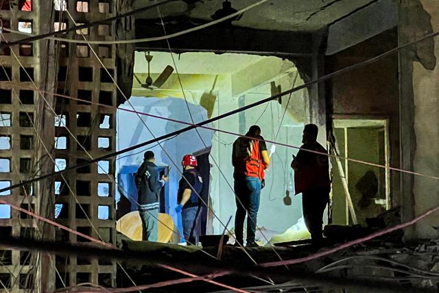 First responders and local residents inspect the damage to a building following an Israeli strike in Tyre, southern Lebanon, on May 28, 2026. The Israeli military said on May 28 it had begun new strikes on Hezbollah infrastructure around the southern Lebanese city of Tyre after issuing an evacuation warning to its residents. (Photo by KAWANT HAJU / AFP)