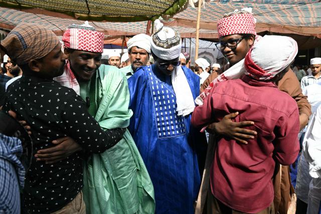 Nigerian and Indian Muslim devotees greet after offering Eid al-Adha prayers at Jama Masjid Khairuddin in Amritsar on May 28, 2026. (Photo by Narinder NANU / AFP)