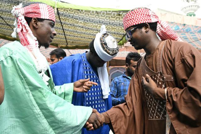 Nigerian Muslim devotees greet each other after offering Eid al-Adha prayers at Jama Masjid Khairuddin in Amritsar on May 28, 2026. (Photo by Narinder NANU / AFP)