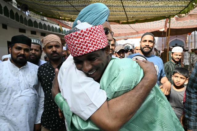 A Sikh man embraces a Nigerian Muslim devotee during Eid al-Adha celebrations at Jama Masjid Khairuddin in Amritsar on May 28, 2026. (Photo by Narinder NANU / AFP)
