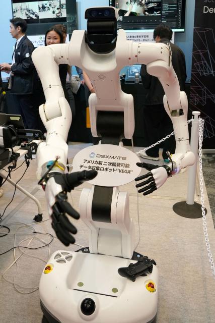 VEGA, a versatile US-built humanoid and dual-arm robot by California-based Dexmate, is displayed at the Humanoids Summit Tokyo 2026 in Tokyo on May 28, 2026. (Photo by Kazuhiro NOGI / AFP)