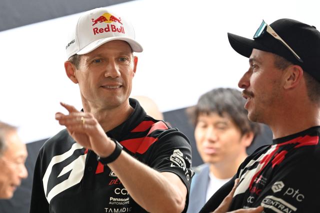 Toyota Gazoo Racing WRT team's Sebastien Ogier of France waves to fans from his service pit in Toyota stadium during the Rally Japan, the 7th round of the FIA World Rally Championships in Toyota city, Aichi prefecture on May 28, 2026. (Photo by Toshifumi KITAMURA / AFP)