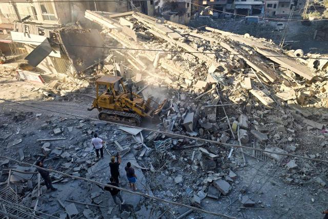 A municipal worker uses a bulldozer to clear debris from a street at the site of an Israeli strike in Tyre, southern Lebanon, on May 28, 2026. The Israeli military said on May 28 it had begun new strikes on Hezbollah infrastructure around the southern Lebanese city of Tyre after issuing an evacuation warning to its residents. (Photo by KAWNAT HAJU / AFP)