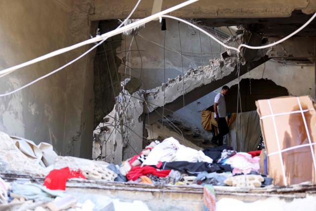A resident walks down the staircase in a destroyed building following a dawn Israeli air raid on the southern Lebanese city of Sidon  on May 28, 2026. Israel the previous day had declared all areas south of Lebanon's Zahrani River - an area roughly 40 kilometres (25 miles) from the border and including Tyre - as "combat zones" and told residents to evacuate ahead of attacks against Iran-backed Hezbollah. Lebanon was drawn into the Middle East war on March 2 when Tehran-backed militant group Hezbollah launched attacks on Israel to avenge the killing of the Iranian leader. Israel has responded with broad strikes across Lebanon and a ground offensive. (Photo by MAHMOUD ZAYYAT / AFP)