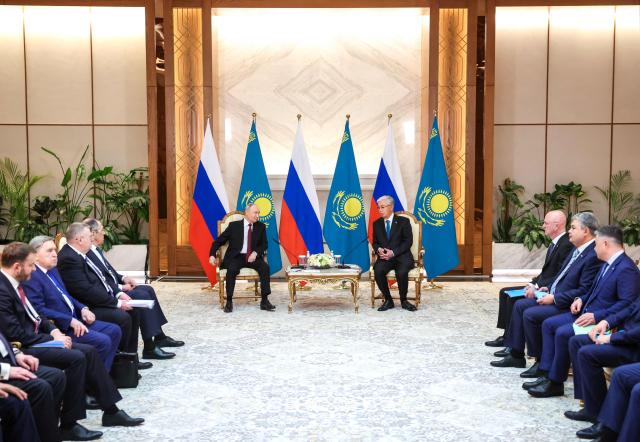 In this pool photograph distributed by the Russian state agency Sputnik Russian President Vladimir Putin (L) and Kazakh President Kassym-Jomart Tokayev (R) meet at the Palace of Independence during Putin's state visit to Kazakhstan in Astana on May 27, 2026. (Photo by Alexander KAZAKOV / POOL / AFP)