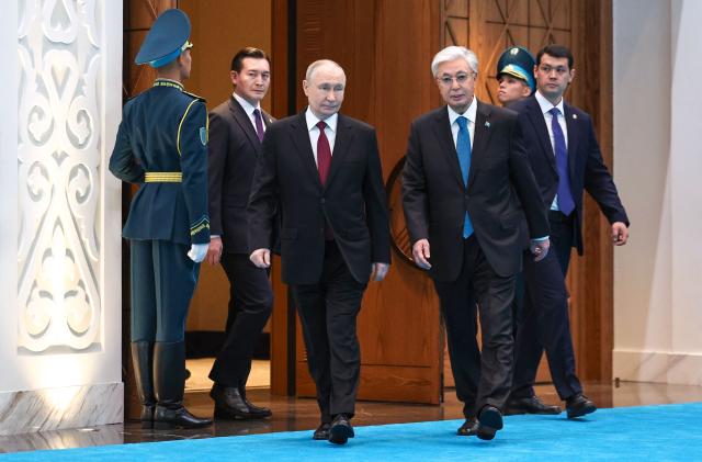 In this pool photograph distributed by the Russian state agency Sputnik Russian President Vladimir Putin (L) and Kazakh President Kassym-Jomart Tokayev (R) attend an official welcoming ceremony at the Palace of Independence during Putin's state visit to Kazakhstan in Astana on May 27, 2026. (Photo by Alexander KAZAKOV / POOL / AFP)