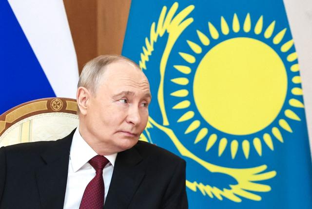 In this pool photograph distributed by the Russian state agency Sputnik Russian President Vladimir Putin meets with Kazakh President at the Palace of Independence during his state visit to Kazakhstan in Astana on May 27, 2026. (Photo by Alexander KAZAKOV / POOL / AFP)