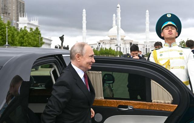 TOPSHOT - In this pool photograph distributed by the Russian state agency Sputnik Russian President Vladimir Putin arrives at the Palace of Independence during his state visit to Kazakhstan in Astana on May 28, 2026. (Photo by Sergei BOBYLYOV / POOL / AFP)