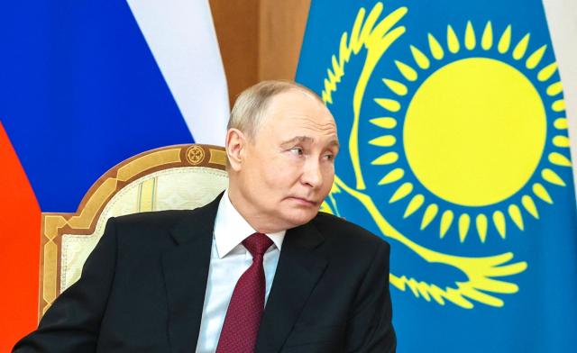 In this pool photograph distributed by the Russian state agency Sputnik Russian President Vladimir Putin meets with Kazakh President at the Palace of Independence during his state visit to Kazakhstan in Astana on May 28, 2026. (Photo by Alexander KAZAKOV / POOL / AFP)