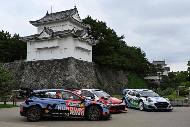 Toyota Gazoo Racing WRT team's Toyota GR Yaris Rally1 car (C), Hyundai Shell Mobis World Rally team's Hyundai i20 N Rally1 car (L) and M-sport Ford World Rally team's Ford Puma Rally1 car (R) are line up in front of the Nagoya castle during the opening ceremony of the Rally Japan, the 7th round of the FIA World Rally Championships in Nagoya city, Aichi prefecture on May 28, 2026. (Photo by Toshifumi KITAMURA / AFP)