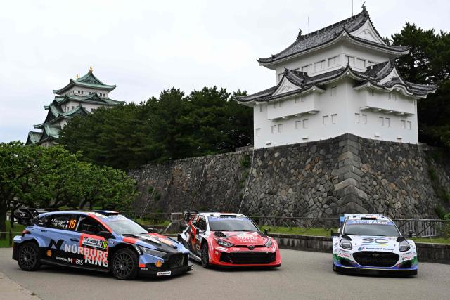 Toyota Gazoo Racing WRT team's Toyota GR Yaris Rally1 car (C), Hyundai Shell Mobis World Rally team's Hyundai i20 N Rally1 car (L) and M-sport Ford World Rally team's Ford Puma Rally1 car (R) are line up in front of the Nagoya castle during the opening ceremony of the Rally Japan, the 7th round of the FIA World Rally Championships in Nagoya city, Aichi prefecture on May 28, 2026. (Photo by Toshifumi KITAMURA / AFP)