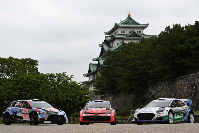 Toyota Gazoo Racing WRT team's Toyota GR Yaris Rally1 car (C), Hyundai Shell Mobis World Rally team's Hyundai i20 N Rally1 car (L) and M-sport Ford World Rally team's Ford Puma Rally1 car (R) are line up in front of the Nagoya castle during the opening ceremony of the Rally Japan, the 7th round of the FIA World Rally Championships in Nagoya city, Aichi prefecture on May 28, 2026. (Photo by Toshifumi KITAMURA / AFP)