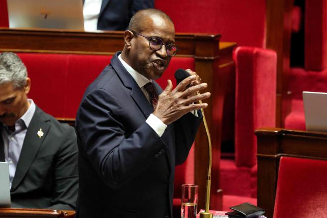 Libertes, Independants, Outre-Mer et Territoires' MP Max Mathiasin (C) speaks during a session to debate his proposed bill aimed at abolishing the slavery-related laws at The National Assembly, France's lower house parliament, in Paris on May 28, 2026. These laws, known as Code Noir ("Black Code") classified enslaved people as "chattels" that could be acquired by a master in the same way as property, or established penalties for escapeincluding the cutting off of ears, branding with a lily, and even the death penalty. (Photo by Ludovic MARIN / AFP)