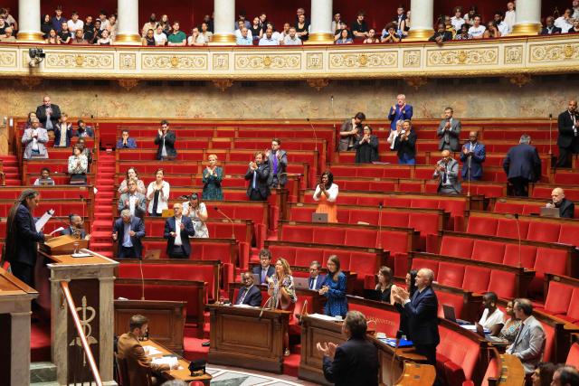 MP's applaud as they listen to Ecologiste et Social's MP Steevy Gustave (L) during a session to debate a proposed bill aimed at abolishing the slavery-related laws at The National Assembly, France's lower house parliament, in Paris on May 28, 2026. These laws, known as Code Noir ("Black Code") classified enslaved people as "chattels" that could be acquired by a master in the same way as property, or established penalties for escapeincluding the cutting off of ears, branding with a lily, and even the death penalty. (Photo by Ludovic MARIN / AFP)