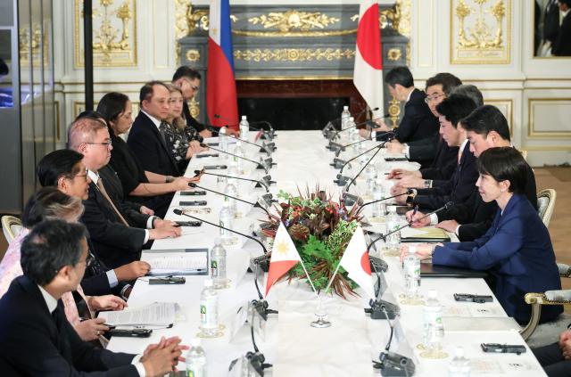 Japan's Prime Minister Sanae Takaichi (R) and Philippines' President Ferdinand Marcos Jr. (3rd L) sit with their delegation during a meeting at the Akasaka Palace State Guest House in Tokyo on May 28, 2026. (Photo by Kiyoshi Ota / POOL / AFP)
