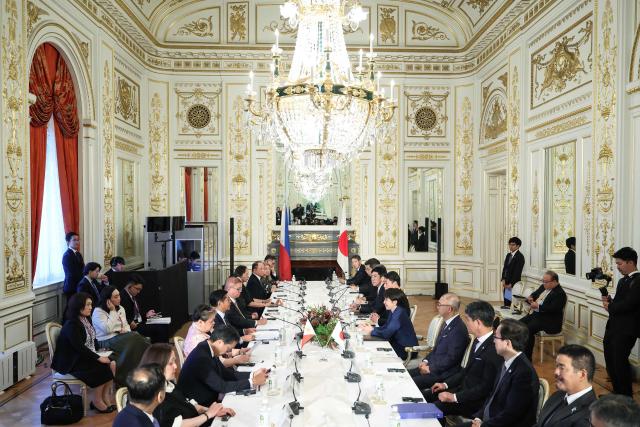 Japan's Prime Minister Sanae Takaichi (C-R) and Philippines' President Ferdinand Marcos Jr. (C-L) sit with their delegation during a meeting at the Akasaka Palace State Guest House in Tokyo on May 28, 2026. (Photo by Kiyoshi Ota / POOL / AFP)