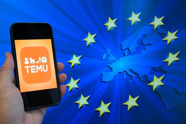 (FILES) This photograph shows the logo of Chinese e-commerce company Temu displayed on a mobile phone holding in front of a screen bearing the European Union logo, in Brussels, on November 4, 2024. The EU slapped a 200-million-euro ($232 million) fine on Chinese-owned online retailer Temu on May 28, 2026 for allowing the sale of illegal products, including dangerous baby toys and defective chargers. (Photo by Nicolas TUCAT / AFP)