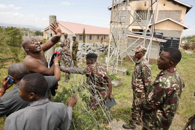 A parent reacts near the building at Utumishi Girls Academy where a deadly fire took place in Gilgil, north of the capital Nairobi on May 28, 2026. A fire in a girls' dormitory in Kenya on May 28 killed 16 children and hospitalised 79 in the latest deadly blaze to hit a school in the east African country. The fire broke out shortly before 1:00 am local time at Utumishi Girls Academy in Nakuru County, around 120 kilometres (75 miles) north of the capital Nairobi, officials said. (Photo by SIMON MAINA / AFP)