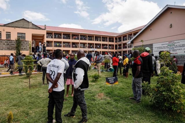 Parents and guardians gather at the assembly area to wait for news of their loved ones at the Utumishi Girls Academy following the deadly fire in Gilgil, north of the capital Nairobi on May 28, 2026. A fire in a girls' dormitory in Kenya on May 28 killed 16 children and hospitalised 79 in the latest deadly blaze to hit a school in the east African country. The fire broke out shortly before 1:00 am local time at Utumishi Girls Academy in Nakuru County, around 120 kilometres (75 miles) north of the capital Nairobi, officials said. (Photo by SIMON MAINA / AFP)