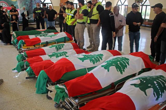 EDITORS NOTE: Graphic content / The bodies of people killed in Israeli strikes, are seen wrapped in Lebanon's flags before the funeral in Tyre, southern Lebanon on May 28, 2026. Lebanon's health ministry said on May 28 that Israeli strikes on the country's south killed at least 11 people, including two children, and wounded 21 others. (Photo by KAWNAT HAJU / AFP)