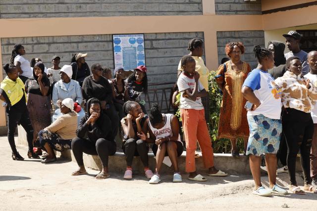 Relatives gather and wait for news of their loved ones at the Utumishi Girls Academy following the deadly fire in Gilgil, north of the capital Nairobi on May 28, 2026. A fire in a girls' dormitory in Kenya on May 28 killed 16 children and hospitalised 79 in the latest deadly blaze to hit a school in the east African country. The fire broke out shortly before 1:00 am local time at Utumishi Girls Academy in Nakuru County, around 120 kilometres (75 miles) north of the capital Nairobi, officials said. (Photo by SIMON MAINA / AFP)