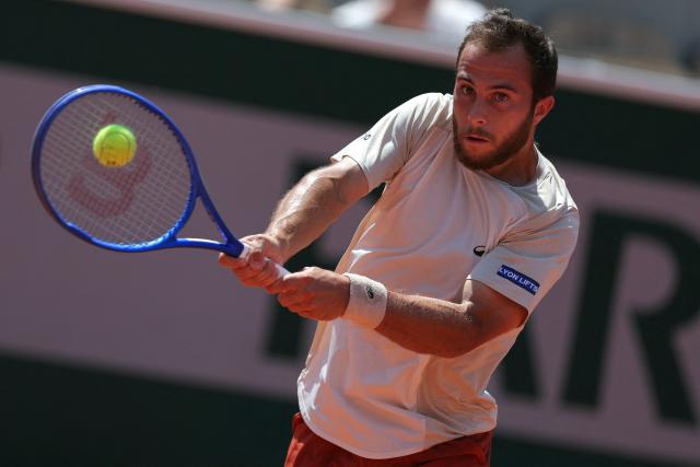 France's Hugo Gaston plays a backhand return to Argentina's Francisco Cerundolo during their men's singles match on day 5 of the French Open tennis tournament on Court Simonne-Mathieu at the Roland-Garros Complex in Paris on May 28, 2026. (Photo by Thomas SAMSON / AFP)