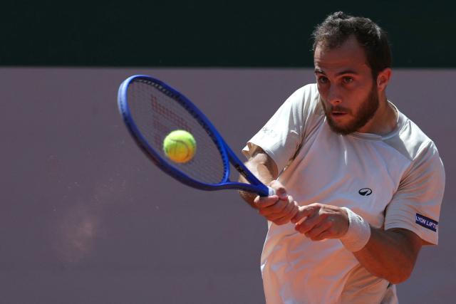 France's Hugo Gaston plays a backhand return to Argentina's Francisco Cerundolo during their men's singles match on day 5 of the French Open tennis tournament on Court Simonne-Mathieu at the Roland-Garros Complex in Paris on May 28, 2026. (Photo by Thomas SAMSON / AFP)
