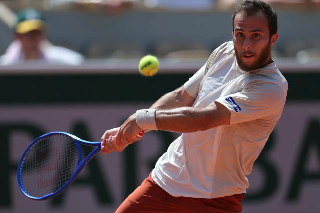 France's Hugo Gaston plays a backhand return to Argentina's Francisco Cerundolo during their men's singles match on day 5 of the French Open tennis tournament on Court Simonne-Mathieu at the Roland-Garros Complex in Paris on May 28, 2026. (Photo by Thomas SAMSON / AFP)