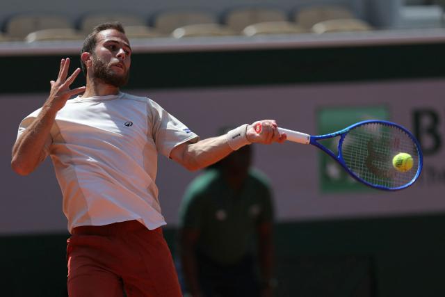 France's Hugo Gaston plays a forehand return to Argentina's Francisco Cerundolo  during their men's singles match on day 5 of the French Open tennis tournament on Court Simonne-Mathieu at the Roland-Garros Complex in Paris on May 28, 2026. (Photo by Thomas SAMSON / AFP)