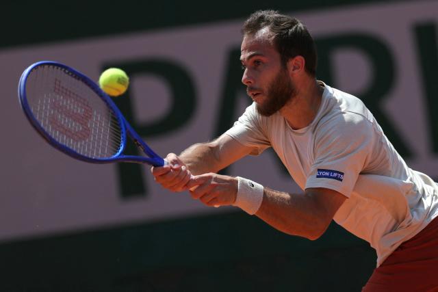 France's Hugo Gaston plays a backhand return to Argentina's Francisco Cerundolo during their men's singles match on day 5 of the French Open tennis tournament on Court Simonne-Mathieu at the Roland-Garros Complex in Paris on May 28, 2026. (Photo by Thomas SAMSON / AFP)