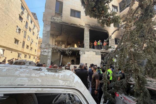 Rescue workers inspect the damage to a building following an Israeli air strike in the Choueifat area, south of Beirut on the outskirts of the capitals southern suburbs, on May 28, 2026. A Lebanese military source told AFP that an Israeli strike hit an apartment south of Beirut on May 28, shortly after Israel's military said it launched a strike on the capital. The Israeli military said it launched an airstrike on the Lebanese capital Beirut after earlier strikes on the country's south killed at least 12 people, including two children, and wounded 21 others. (Photo by Ibrahim AMRO / AFP)