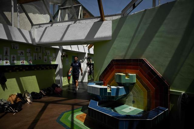A man walks under the glass-roofed corridor of the Isle Verte primary school which closes its doors on May 28 and 29 afternoon after a heatwave pushed temperatures up to 53°C at the beginning of the week, in Soustons, south-western France, on May 28, 2026. Western Europe faced another day of record-breaking temperatures as a heatwave pushed the mercury well above normal levels for May. A so-called "heat dome" of warm air from northern Africa trapped under a high-pressure system over western Europe is behind the sort of heat not usually seen until high summer. (Photo by Philippe LOPEZ / AFP)