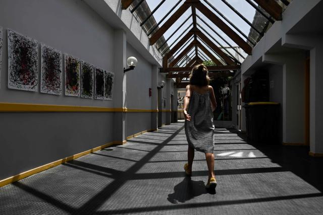 A child walks along the glass-roofed corridor of the Isle Verte primary school which closes its doors on May 28 and 29 afternoon after a heatwave pushed temperatures up to 53°C at the beginning of the week, in Soustons, south-western France, on May 28, 2026. Western Europe faced another day of record-breaking temperatures as a heatwave pushed the mercury well above normal levels for May. A so-called "heat dome" of warm air from northern Africa trapped under a high-pressure system over western Europe is behind the sort of heat not usually seen until high summer. (Photo by Philippe LOPEZ / AFP)