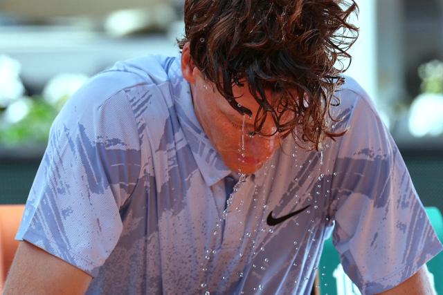 Italy's Jannik Sinner tries to cool down during a break of play in his men's singles match against Argentina's Juan Manuel Cerundolo on day 5 of the French Open tennis tournament on Court Philippe-Chatrier at the Roland-Garros Complex in Paris on May 28, 2026. (Photo by ALAIN JOCARD / AFP)