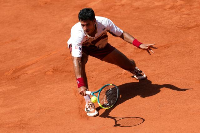 Paraguay's Adolfo Daniel Vallejo hits a half volley to France's Moise Kouame during their men's singles match on day 5 of the French Open tennis tournament on Court Suzanne-Lenglen at the Roland-Garros Complex in Paris on May 28, 2026. (Photo by Dimitar DILKOFF / AFP)