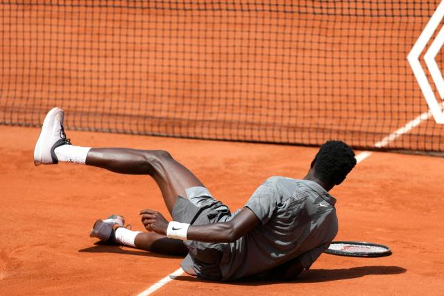 France's Moise Kouame falls on the court as he plays against Paraguay's Adolfo Daniel Vallejo during their men's singles match on day 5 of the French Open tennis tournament on Court Suzanne-Lenglen at the Roland-Garros Complex in Paris on May 28, 2026. (Photo by Dimitar DILKOFF / AFP)