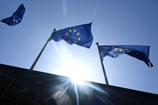 A photograph taken on May 28, 2026 shows the European flags flapping in the breeze in outside the EU headquarters in Brussels. (Photo by Nicolas TUCAT / AFP)
