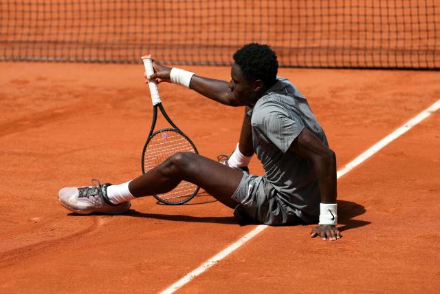 France's Moise Kouame sits on the court after falling during his men's singles match against Paraguay's Adolfo Daniel Vallejo on day 5 of the French Open tennis tournament on Court Suzanne-Lenglen at the Roland-Garros Complex in Paris on May 28, 2026. (Photo by Dimitar DILKOFF / AFP)
