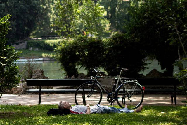 A man rests in the shade of tree at Valentino Park in Turin, northwestern Italy, during an early-season heatwave in Europe, on May 28, 2026. (Photo by MARCO BERTORELLO / AFP)