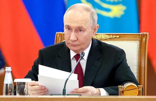 In this pool photograph distributed by the Russian state agency Sputnik Russian President Vladimir Putin meets with Kazakh President at the Palace of Independence during his state visit to Kazakhstan in Astana on May 28, 2026. (Photo by Alexander KAZAKOV / POOL / AFP)