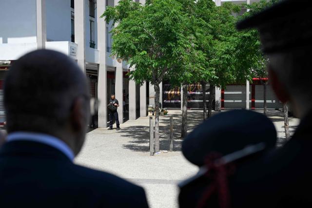 France's Interior Minister Laurent Nunez (L from behind) stands at Place des Amaryllis by the site of a deadly shooting during a visit of the Les Moulins neighbourhood in Nice, south-eastern France on May 28, 2026. Two men and a woman suspected of being involved in the shooting that left two people dead and six injured in Nice on May 11 have been charged and remanded in custody, in a new case illustrating the turf wars associated with drug-related gang activity. (Photo by Frederic DIDES / AFP)