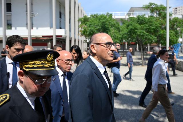 France's Interior Minister Laurent Nunez (C) and Prefect of the Alpes-Maritimes department Laurent Hottiaux (L) arrive at Place des Amaryllis during a visit of the Les Moulins neighbourhood in Nice, south-eastern France on May 28, 2026. (Photo by Frederic DIDES / AFP)