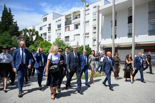 France's Interior Minister Laurent Nunez (C), mayor of Nice Eric Ciotti (5thR), UDR's MP Bernard Chaix (3rdL), Prefect of the Alpes-Maritimes department Laurent Hottiaux (5thL) and UDR's MP Christelle D'Intorni (6thR) arrive at Place des Amaryllis during a visit of the Les Moulins neighbourhood in Nice, south-eastern France on May 28, 2026. (Photo by Frederic DIDES / AFP)