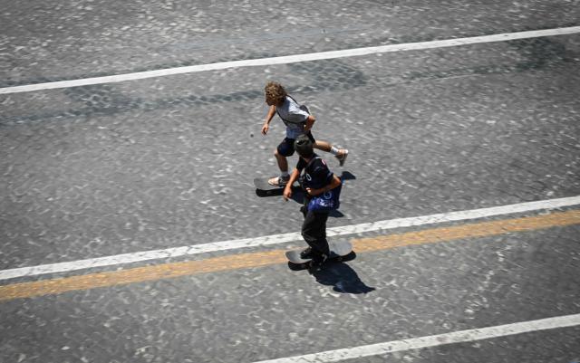 Young men skateboard along the Imperial Forum in Rome on May 28, 2026. (Photo by Tiziana FABI / AFP)