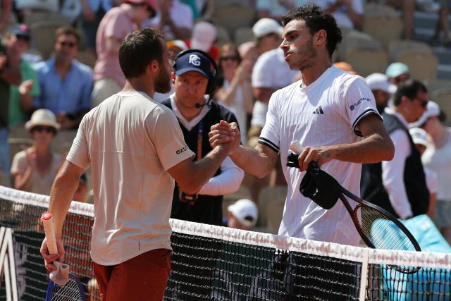 Argentina's Francisco Cerundolo (R) comforts France's Hugo Gaston after his victory over the French player during their men's singles match on day 5 of the French Open tennis tournament on Court Simonne-Mathieu at the Roland-Garros Complex in Paris on May 28, 2026. (Photo by Thomas SAMSON / AFP)