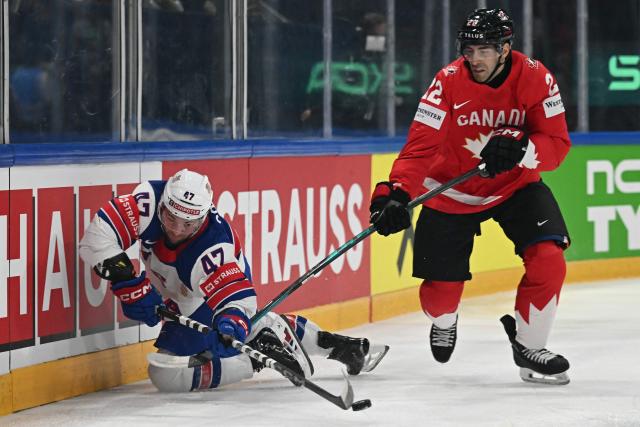 USA's forward #47 Paul Cotter (L) and Canada’s defender #22 Evan Bouchard vie for the puck during the IIHF Ice Hockey Men's World Championship quarter-final match between Canada and USA in Fribourg, Switzerland on May 28, 2026. (Photo by Fabrice COFFRINI / AFP)