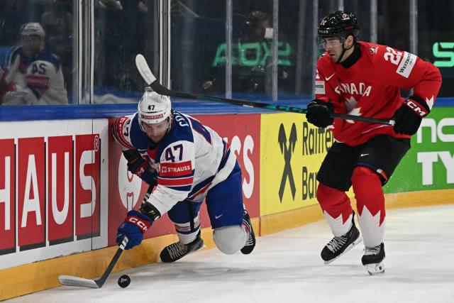 USA's forward #47 Paul Cotter (L) and Canada’s defender #22 Evan Bouchard vie for the puck during the IIHF Ice Hockey Men's World Championship quarter-final match between Canada and USA in Fribourg, Switzerland on May 28, 2026. (Photo by Fabrice COFFRINI / AFP)