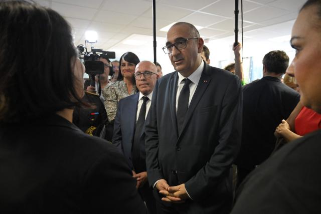France's Interior Minister Laurent Nunez (C) and mayor of Nice Eric Ciotti (C-L) meet with representatives of local associations during a visit to the Les Moulins neighbourhood in Nice, south-eastern France on May 28, 2026. Two men and a woman suspected of being involved in a shooting that left two people dead and six injured in Nice on May 11 in the Les Moulins district of Nice have been charged and remanded in custody, in a new case illustrating the turf wars associated with drug-related gang activity. (Photo by Frederic DIDES / AFP)